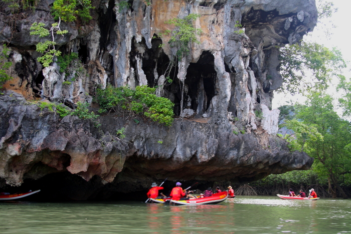 sea canoeing rock overhang Sea canoeing in Phang Nga Bay, Thailand